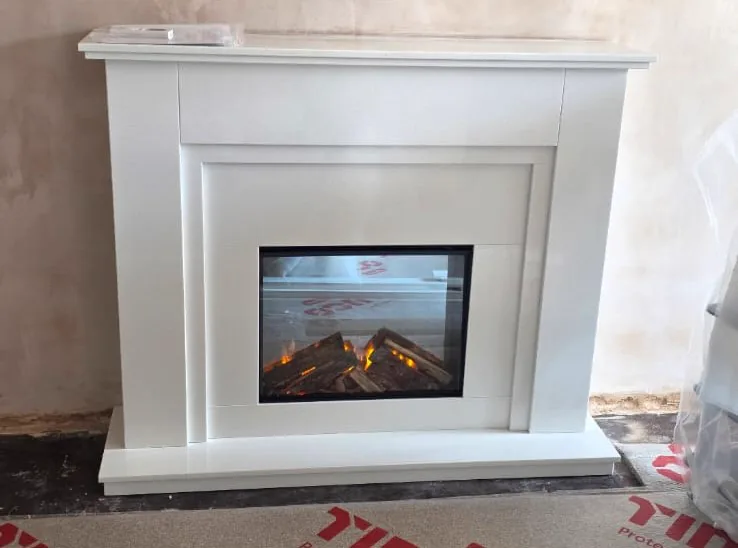 A Sierra fireplace in Blanco Micro marble with a Celsi DLX 600XT electric fire, fitted flat to the wall in a Redditch home