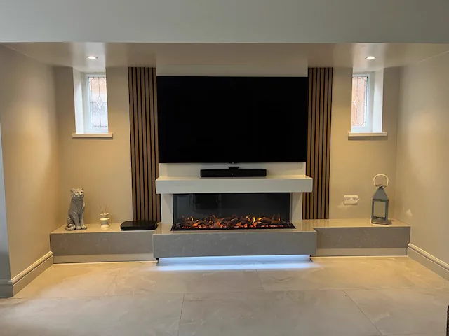 A contemporary media wall in Shirley with a Tucson marble suite, Firez 1250 fire and matching marble benches either side