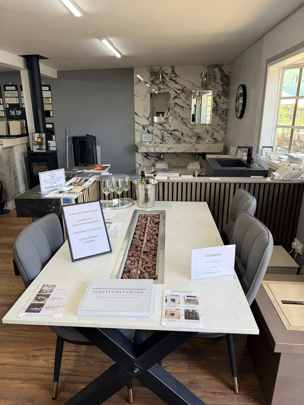 A made-to-measure stone dining table with upholstered chairs in the showroom
