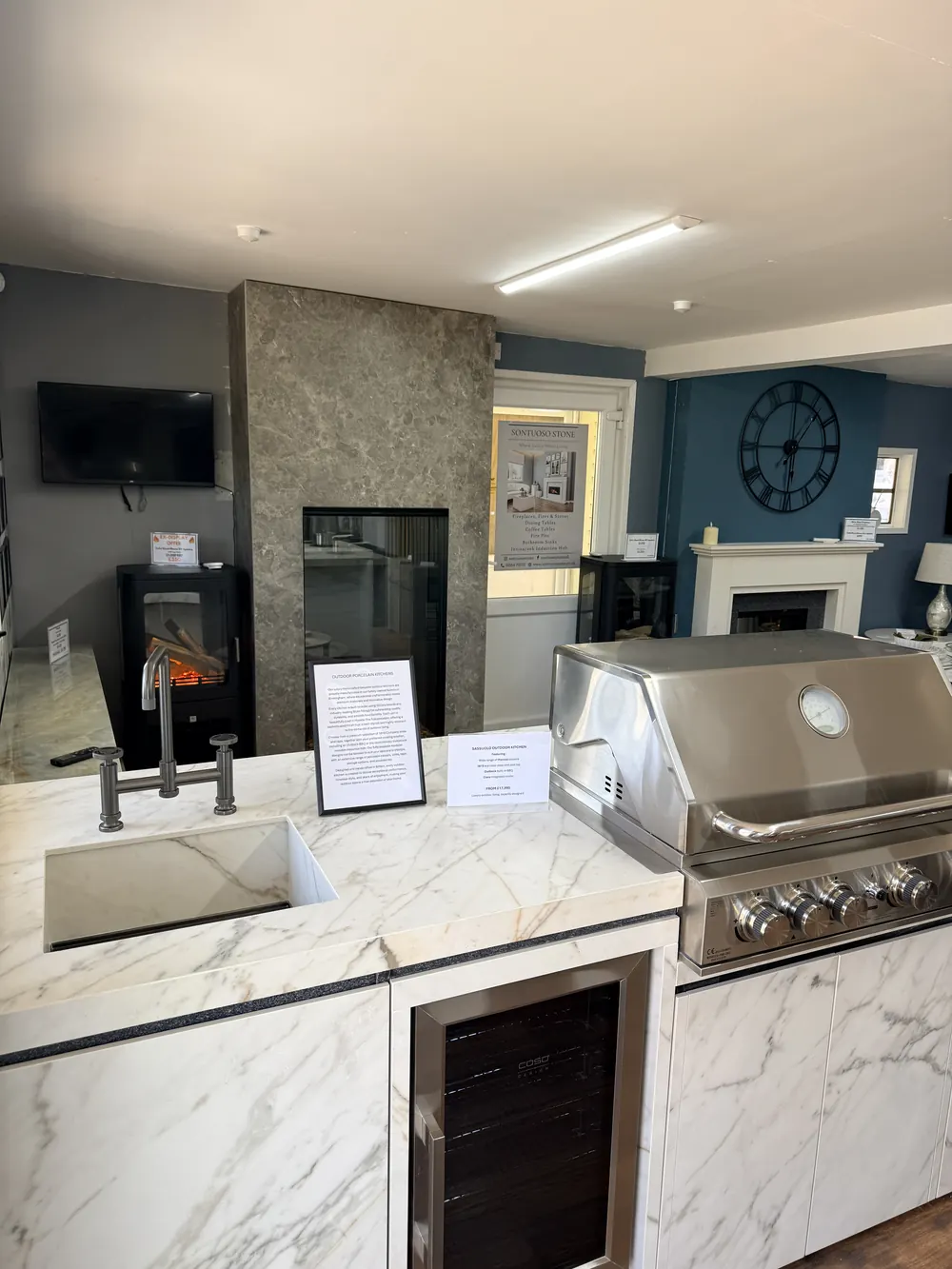 The outdoor kitchen corner of the showroom, with a porcelain worktop and built-in barbecue