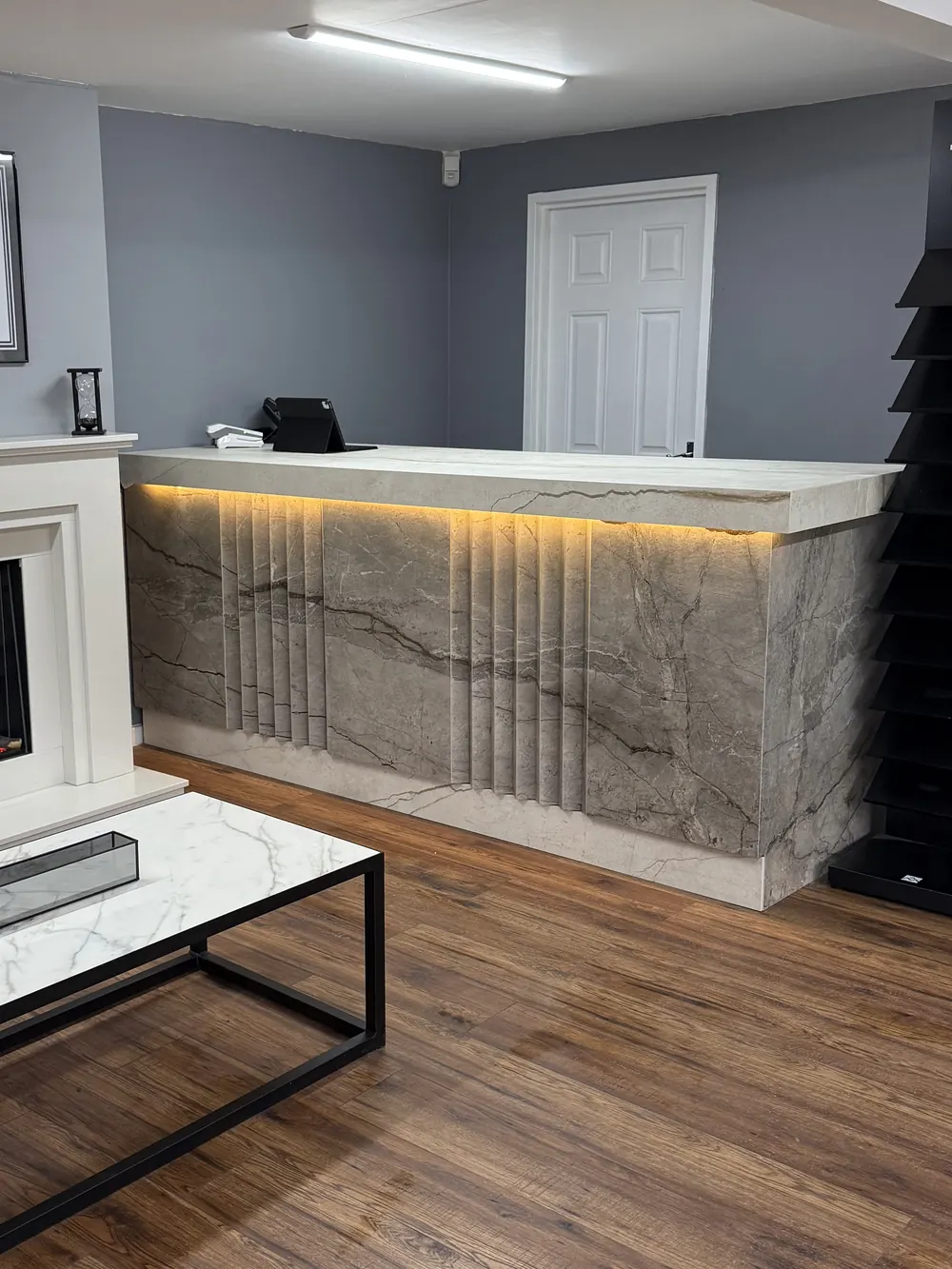 The Sontuoso Stone welcome desk, fronted with fluted marble