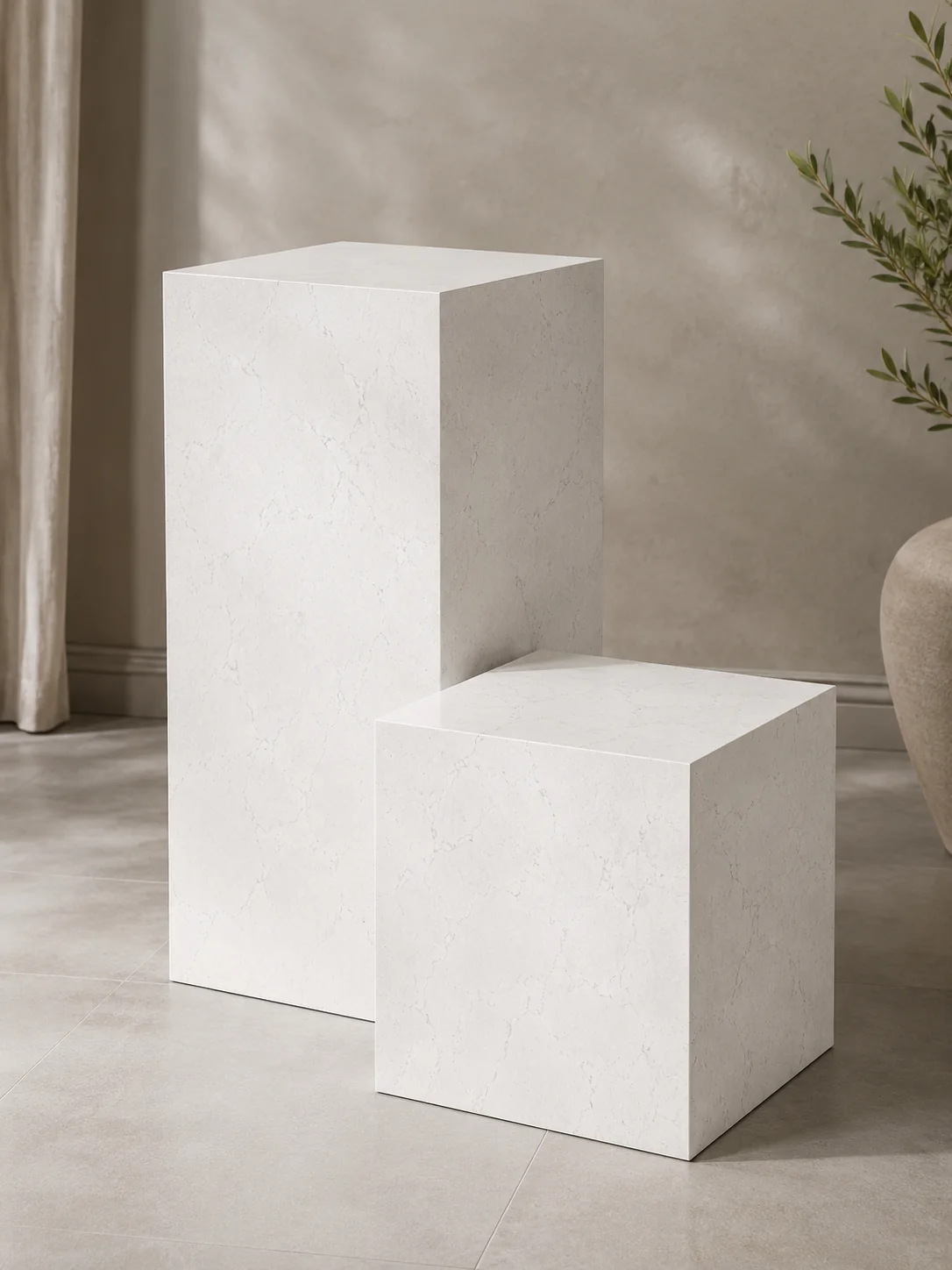 Stone pedestal and cube accent tables shown as a set
